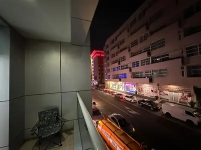 a view of a city street at night with cars at Prime Partition Room in Al Barsha 1 Near Metro in Dubai