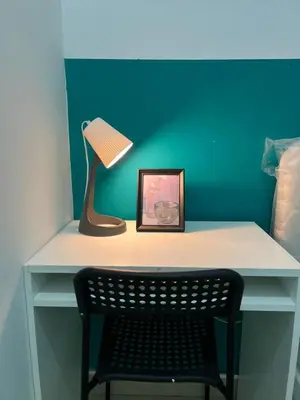 a desk with a lamp and a picture and a chair at Short Stay Partition Room in Al Barsha 1 Near Mashreq Metro in Dubai