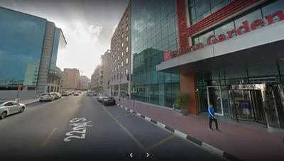 a person walking down a street in a city at Short Stay Partition Room in Al Barsha 1 Near Mashreq Metro in Dubai