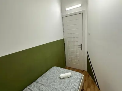 a room with a bed and a door with a towel on it at Bachelor Partition Room in Tecom Near Internet City Metro in Dubai
