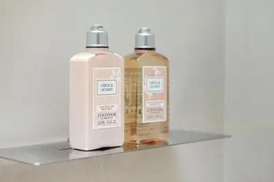 two bottles of soap sitting on a shelf at Luxurious 2BR apt with panoramic Marina view in Dubai