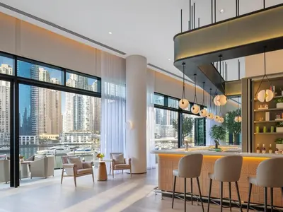 a lobby with a bar with a view of the city at Luxurious 2BR apt with panoramic Marina view in Dubai