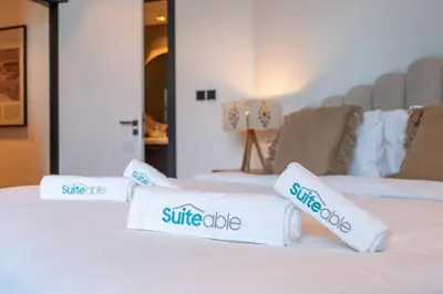 three white pillows sitting on top of a bed at Ranch Living 1 bedroom apartment in Business Bay by Suiteable in Dubai