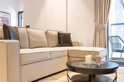 a living room with a couch and a table at Ranch Living 1 bedroom apartment in Business Bay by Suiteable in Dubai
