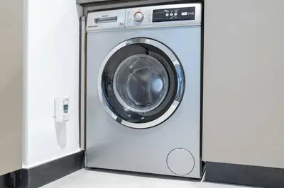 a white washing machine in a room at Ranch Living 1 bedroom apartment in Business Bay by Suiteable in Dubai