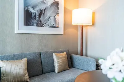 a living room with a couch and a table at Phineek Elegant Studio Canal View Maison Prive Business Bay in Dubai