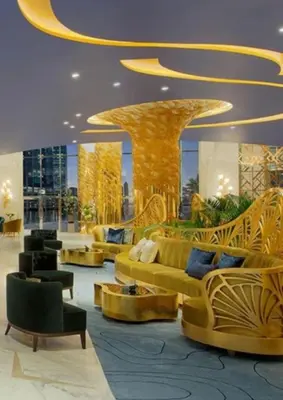 a lobby with couches and chairs in a building at Phineek Elegant Studio Canal View Maison Prive Business Bay in Dubai