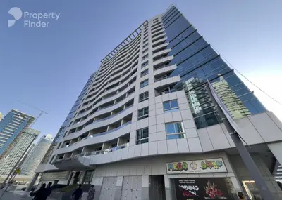 a tall building with people walking in front of it at Elite Studio at Dubai Marina in Dubai