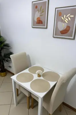a white table and chairs in a room at Elite Studio at Dubai Marina in Dubai