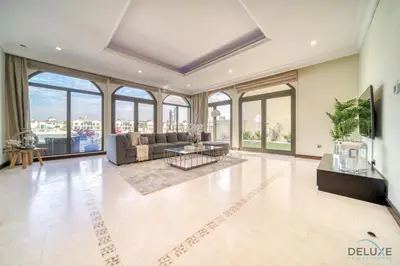 a living room with a couch and a table at Premier 6BR Villa with Assistant's Room and Private Pool in Frond E Palm Jumeirah by Deluxe Holiday Homes in Dubai