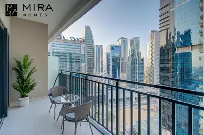a balcony with chairs and a view of the city at Mira Holiday Homes - Serviced apartment in Zada Tower in Dubai