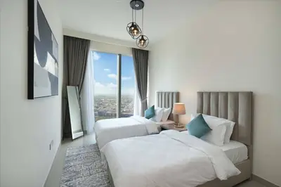 a hotel room with two beds and a window at Chic 2-Bedroom Downtown Gem in Dubai