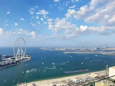 an aerial view of a city with a ferris wheel in the water at FAM Living- Luxe Penthouse in JBR Marina - Panaromic Sea View in Dubai