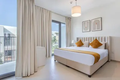 a bedroom with a bed and a large window at Three Bedroom Villa with Maid Room in Tilal Al Ghaf by The S Holiday Homes in Dubai