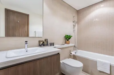 a bathroom with a sink and a toilet and a tub at Three Bedroom Villa with Maid Room in Tilal Al Ghaf by The S Holiday Homes in Dubai