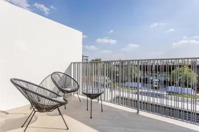 two chairs sitting on a balcony with a view at Three Bedroom Villa with Maid Room in Tilal Al Ghaf by The S Holiday Homes in Dubai