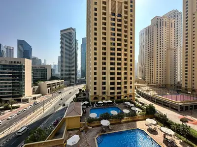 a view of a city with a pool and buildings at Sun, Sand, and FUN - King Bed, Sofa Bed! Sleeps 4 in Dubai