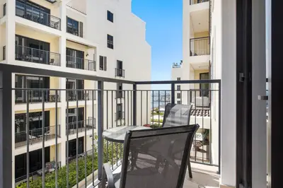 a balcony with two chairs and a table at Spacious 1 bed in La Mer - 1 min to the beach in Dubai
