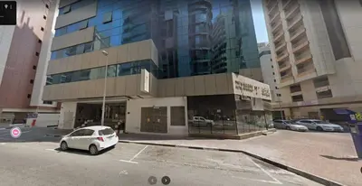 a white car parked in front of a building at Brand New Private Partition Near MOE Metro in Dubai