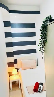 a small room with a bed and a mirror at Brand New Private Partition Near MOE Metro in Dubai