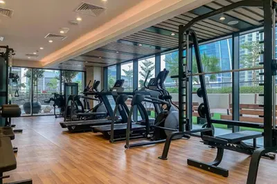 a gym with treadmills and ellipticals in a building at Stylish Apartment in Dubai