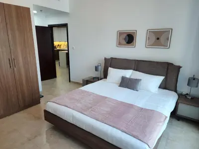 a bedroom with a large bed with white sheets at Preatoni Tower - JLT by Golden Casa in Dubai