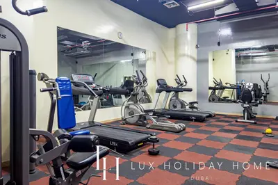 a gym with several exercise bikes in a room at LUX The Marina View Suite 2 in Dubai