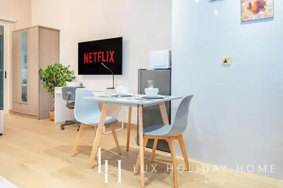 a dining room with a table and chairs at LUX The Marina View Suite 2 in Dubai