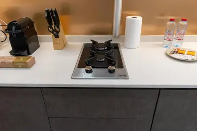 a stove top on a counter in a kitchen at Nice Studio in heart of JVC - Pantheon Elysée - Dubai in Dubai