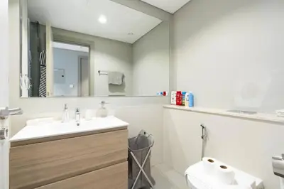a bathroom with a sink and a toilet and a mirror at 1 Bedroom in Zada Tower - Business Bay - Dubai in Dubai