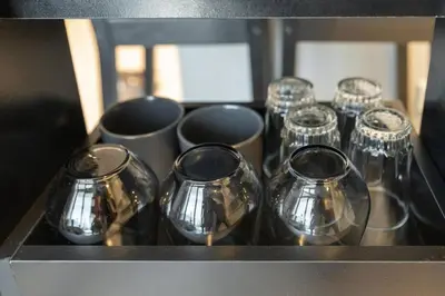 a group of silver cups sitting on a counter at 1 Bedroom in Zada Tower - Business Bay - Dubai in Dubai