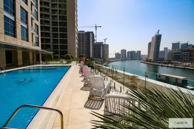 a swimming pool on the side of a building at Studio with Burj Khalifa View in Dubai