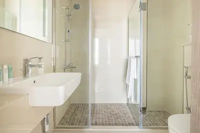 a bathroom with a sink and a shower at Frank Porter - Bluebell Residence JVC in Dubai