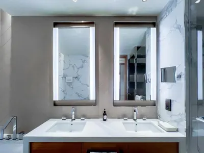 a bathroom with two sinks and two mirrors at #37 Luxury - 2BR in The Address Dubai Opera - Downtown in Dubai