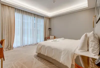 a white bedroom with a large bed and large windows at #37 Luxury - 2BR in The Address Dubai Opera - Downtown in Dubai