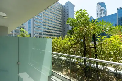 a balcony with trees and buildings in a city at White Sage- Damac Vera Residences 417 in Dubai