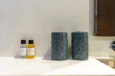 two green vases sitting on a kitchen counter at White Sage- Damac Vera Residences 417 in Dubai