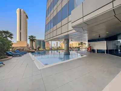 a view of a building with a swimming pool at Great 2BR APT Ocean Heights in Dubai