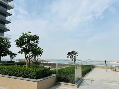 a glass balcony with a view of the ocean at StoneTree - Luxurious with Private Beach Access in Dubai