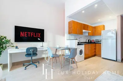 a kitchen with a desk and a table with chairs at LUX The Marina View Suite 1 in Dubai
