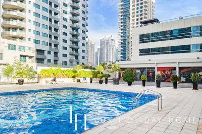a swimming pool in a city with tall buildings at LUX The Marina View Suite 1 in Dubai
