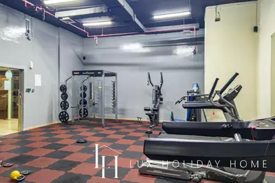a gym with cardio equipment in a room at LUX The Marina View Suite 1 in Dubai