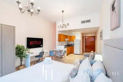 a living room with a couch and a table at LUX The Marina View Suite 1 in Dubai