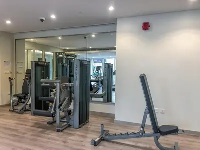 a gym with several treadmills and a mirror at GuestReady - Vibrant Retreat in Dubai's Heart in Dubai