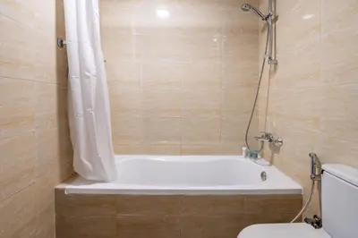 a bathroom with a bath tub and a toilet at GuestReady Holiday Homes - Urban Elegance in JLT in Dubai
