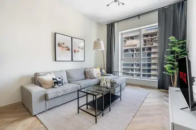a living room with a couch and a table at GuestReady Holiday Homes - Urban Elegance in JLT in Dubai