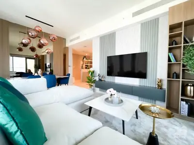 a living room with white furniture and a flat screen tv at Luxury Burj Royale Apt Balcony Burj Khalifa View in Dubai