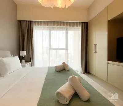 two towels on a bed in a hotel room at Burj Royale Luxury 1B Balcony & City View Downtown in Dubai