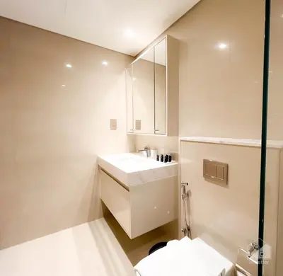 a bathroom with a sink and a toilet at Burj Royale Luxury 1B Balcony & City View Downtown in Dubai
