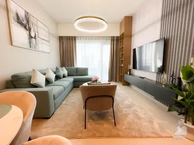 a living room with a couch and a tv at Burj Royale Luxury 1B Balcony & City View Downtown in Dubai